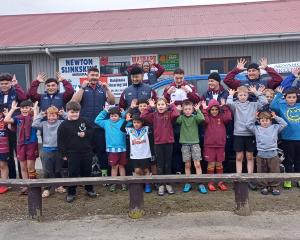 Mataura Rugby Club junior players and eight Southland Stags team members pause for a photograph...