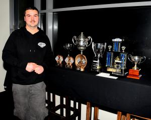 Eleven-time Southland Sports Car Club Champion Liam MacDonald with his trophy haul at this year’s...