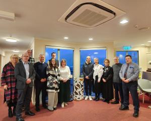 J Fraser &amp; Sons staff surround carver Greg Houkamau (fifth from right) at the unveiling and...