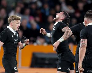 Damian McKenzie and an in pain T J Perenara. Photo: Getty Images 