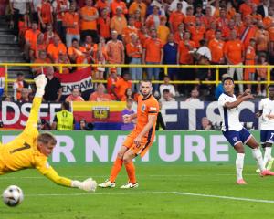 Ollie Watkins watches as his last minute shot goes past Dutch keeper Verbruggen to send England...