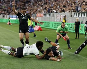 Billy Proctor of the All Blacks scores a try with teammate Caleb Clarke against Fiji during the...