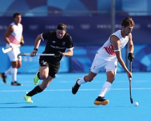 Antoine Kina of Team Belgium runs with the ball whilst under pressure from Hayden Phillips of...