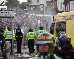 Riot police confront protesters after disorder broke out in Southport following the stabbing...