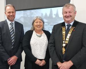 Ashburton deputy mayor Liz McMillan, standing between chief executive Hamish Riach and Mayor Neil...