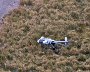 The crashed Squirrel helicopter at the mouth of the Paringa River on Saturday. PHOTO: SUPPLIED 