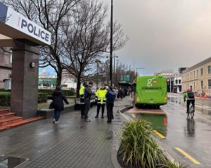 Police talk to security staff in Dunedin's bus hub. Photo: Gregor Richardson