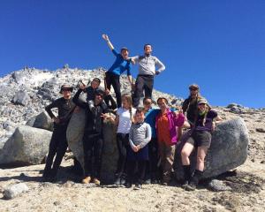 Lulu Sun (top left) on Mt Titiroa in Fiordland, with family and friends, and bush guide and Otago...