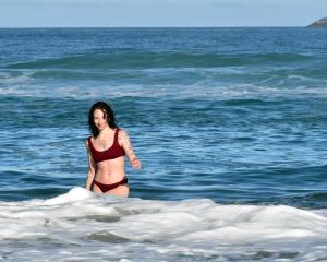 Auckland visitor Indi Mortimore takes a dip in the ocean at St Clair in April. According to Stats...
