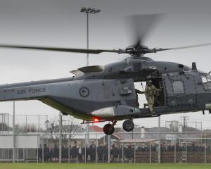 King’s High School pupils watch as an NH90 helicopter lands on the school’s field. PHOTOS: GERARD...
