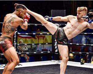 Jack Ferguson kicks out in a competitive mixed martial arts fight in Thailand.