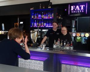 Bridgit Anderson photographs Ben Johnston and Tess McAtamney during their shift at Fat Sally’s...
