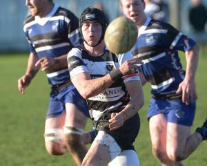 A Kaik player spins the ball away at a premier club rugby match between Kaikorai and Southern at...