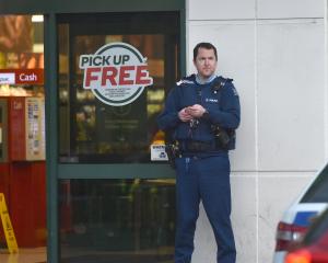 An armed officer outside Countdown in central Dunedin. Photo: Gregor Richardson