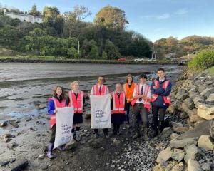Bayfield High School students clean up the shoreline at Andersons Bay Inlet with support from...