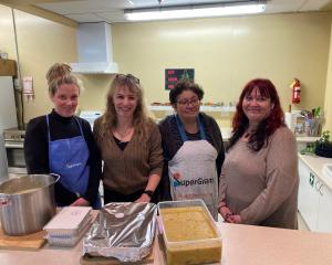 Departing SuperGrans manager Sandy McKay (second from left) gathers with regular Monday cooking...