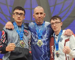 Celebrating with their medal haul are (from left) Will Knight, coach Wayne Knight and Ollie Berry...