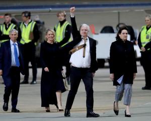 WikiLeaks founder Julian Assange gestures as he arrives at Canberra Airport. PHOTO: GETTY IMAGES