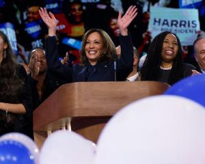 Kamala Harris waves from the Democratic National Convention stage. PHOTO: REUTERS