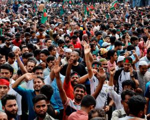 People celebrate in Dhaka after the resignation of Bangladeshi Prime Minister Sheikh Hasina....