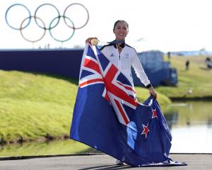 Lydia Ko poses with her gold medal and the New Zealand flag as she celebrates her Olympic victory...