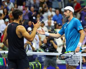 Botic van de Zandschulp (right) shakes hands with Carlos Alcaraz after his second round match win...