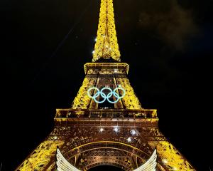 The Eiffel Tower, adorned with the Olympics Rings, illuminated during the opening ceremony of the...