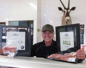 The Fridge Butchery owner and operator Jayne McMillan shows off the new awards the business...