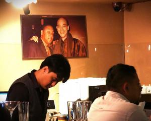 A photograph hanging in the House of Blues &amp; Jazz shows owner Dongfu Lin with American...