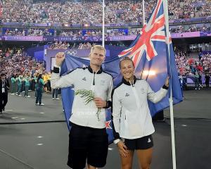 Finn Butcher and Dame Lisa Carrington fly the flag for the New Zealand team in Stade de France at...