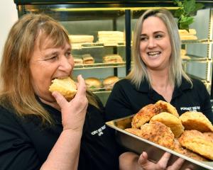 South Dunedin Forget Me Not Cafe baker Patricia Mcvicar takes a bite out of a cheese scone as...