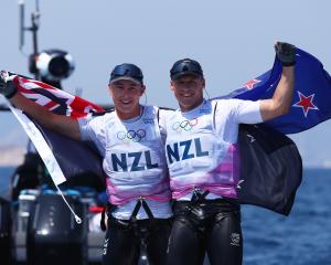 Isaac McHardie and Will McKenzie celebrate after winning silver in the men's 49er skiff. Photo:...