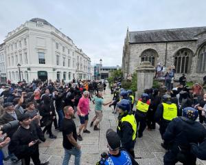 Police confront activists and protesters at Guildhall Square in Plymouth amid ongoing unrest...