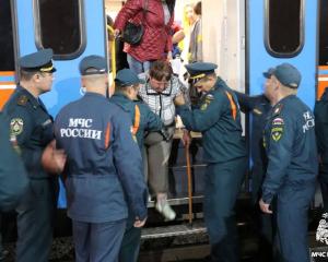 Evacuees from Russian border towns are helped from a train in the Russian city of Oryol. Photo:...