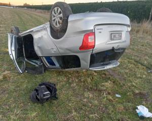 The driver of this Toyota Corolla walked away after it rolled multiple times into a field on...