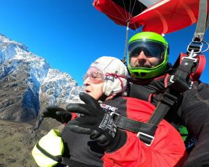 Betty Phillips enjoying her first tandem parachute jump with her NZONE Skydive instructor Boris,...