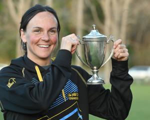 Hill City-University runner Rebekah Aitkenhead admires a trophy that was donated by New Zealand...