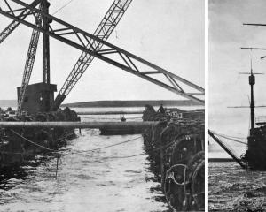 Crane barges are prepared to lift scuppered German WW1 naval vessels from the seabed of Scapa...