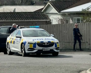 Armed police set up road spikes at the bottom of Motueka Street. Photo: Supplied