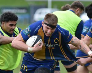 Otago lock Fabian Holland charges ahead with ball as A-One Lolofie (left) and Ben Lopas play the...