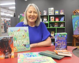 Project manager Pauline Smith shows books by authors and illustrators who are coming to the Books...