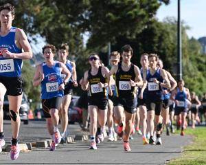 Liam Chesney leads from the start on his way to win the senior men's 5km race in the Otago road...