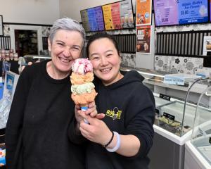 Former Rob Roy Dairy owner Liz Watson hands the baton (also known as an ice cream) to new owner...