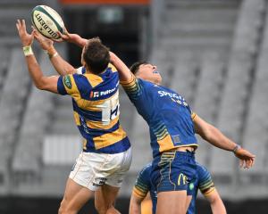 Otago wing Josh Whaanga is at full stretch to steal the high ball from Bay of Plenty fullback...