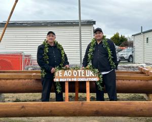 Master carver Taua Papatua (left) and his son Samuel Papatua showing proudly the vaka they carved...