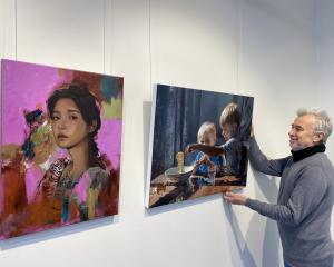 Otago Art Society councillor and exhibition lead for "The Ultimate Showcase" Rob McGee adjusts...