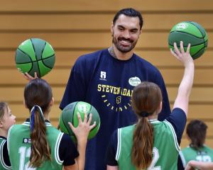 New Zealand NBA star Steven Adams charms some children during his basketball camp at the Edgar...