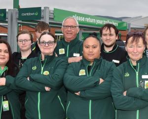 First Union representative Angus Wilson (far right) stands with staff members outside Woolworths...