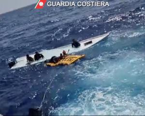 Coastguard members take part in the rescue near the Sicilian island of Lampedusa. Photo: Guardia...