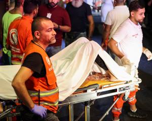 A person is carried outside American University of Beirut Medical Center after Hezbollah fighters...